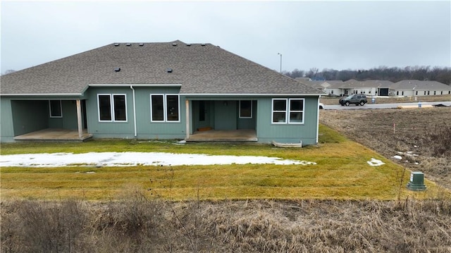 back of property featuring a yard and a patio area