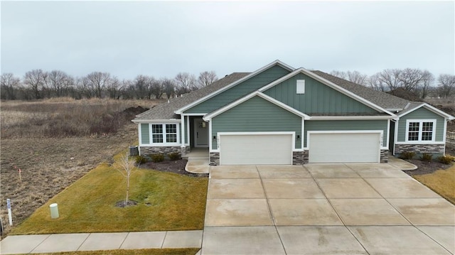 craftsman-style home with a garage and a front yard