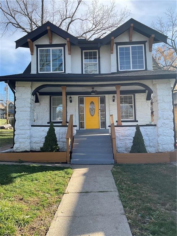 view of front facade with covered porch and stone siding