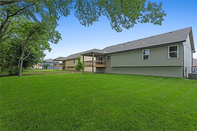 1316 N Holland Ct, Independence, MO 64056 - rear view of property featuring a yard and roof with shingles