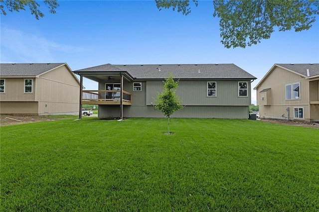 1316 N Holland Ct, Independence, MO 64056 - back of house featuring a ceiling fan, a lawn, and cooling unit