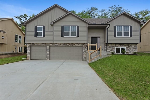 1316 N Holland Ct, Independence, MO 64056 - split foyer home featuring board and batten siding, an attached garage, a front lawn, and concrete driveway