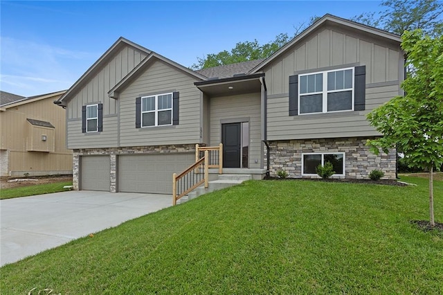 1316 N Holland Ct, Independence, MO 64056 - raised ranch featuring board and batten siding, stone siding, a garage, and concrete driveway