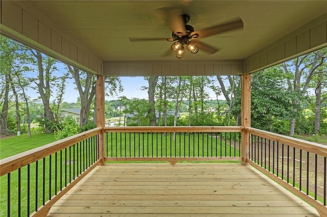 1316 N Holland Ct, Independence, MO 64056 - wooden terrace with a ceiling fan, a yard, and view of wooded area