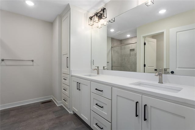 1316 N Holland Ct, Independence, MO 64056 - full bath featuring double vanity, a stall shower, baseboards, and recessed lighting