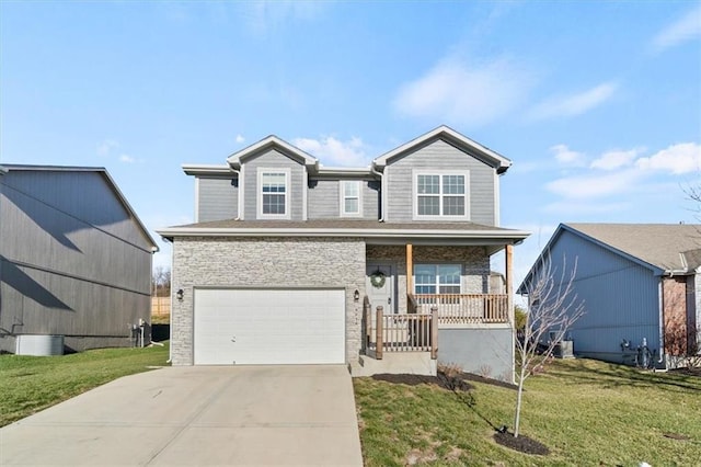 view of front of house with covered porch, a garage, and a front yard