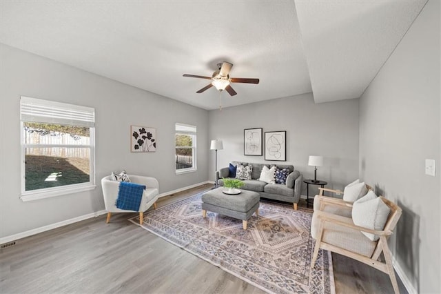 living room featuring ceiling fan and hardwood / wood-style floors