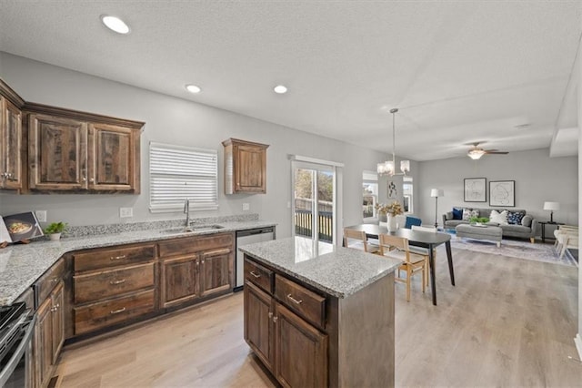 kitchen featuring sink, a center island, light hardwood / wood-style floors, and appliances with stainless steel finishes