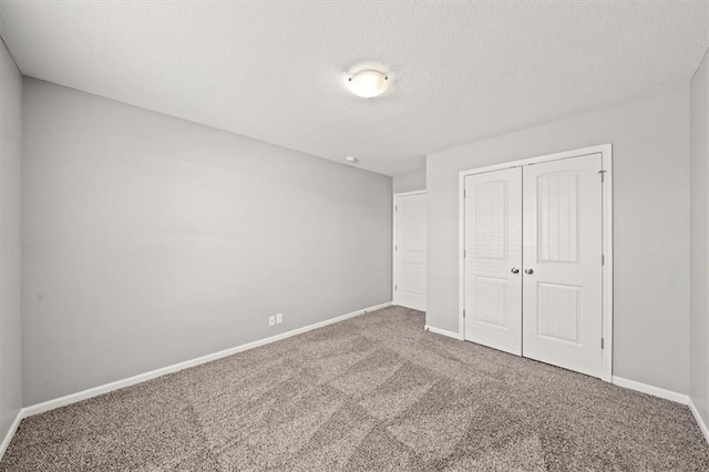 unfurnished bedroom featuring carpet flooring and a closet