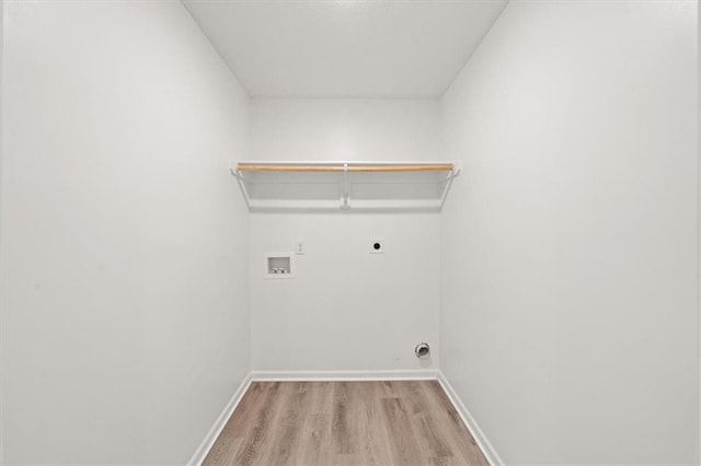 washroom with hookup for an electric dryer, light hardwood / wood-style floors, and hookup for a washing machine