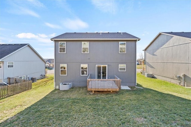 rear view of property featuring a yard, a deck, and central air condition unit