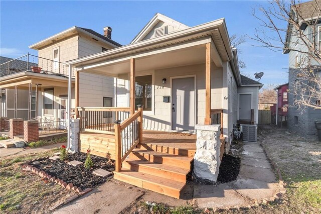 view of front facade featuring covered porch and central AC unit