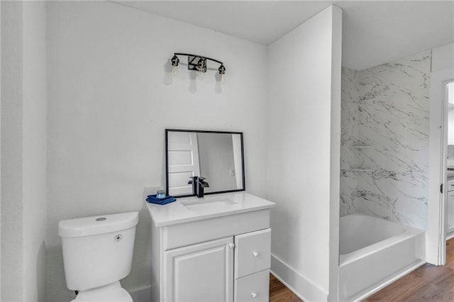 full bathroom featuring vanity, toilet, wood-type flooring, and tiled shower / bath combo