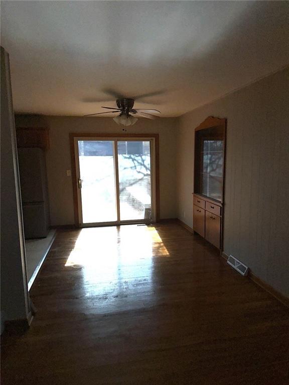 unfurnished living room featuring dark hardwood / wood-style floors and ceiling fan