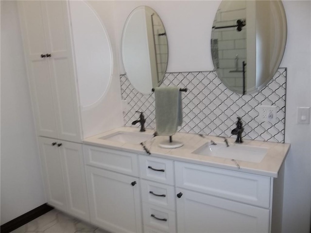 bathroom with tasteful backsplash and vanity