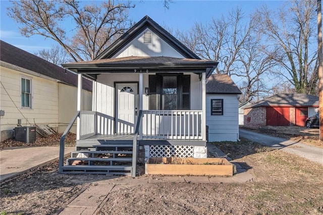 bungalow-style house featuring central AC unit and a porch