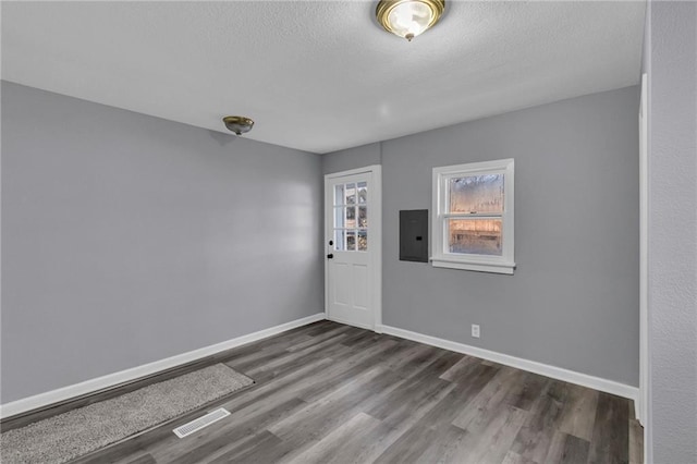 entryway featuring a textured ceiling, electric panel, and dark hardwood / wood-style floors