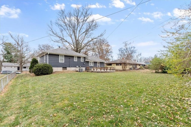 view of yard featuring central AC and a deck