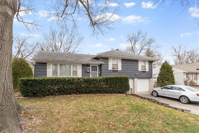 split level home with a garage and a front yard