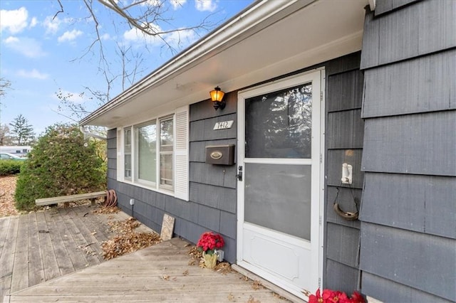 view of exterior entry with a deck