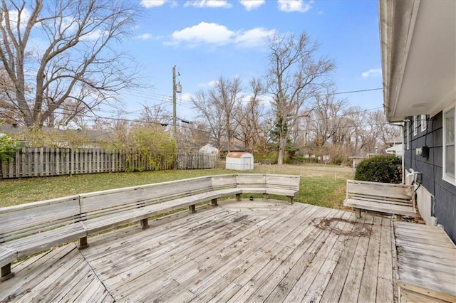 deck with a lawn and a shed