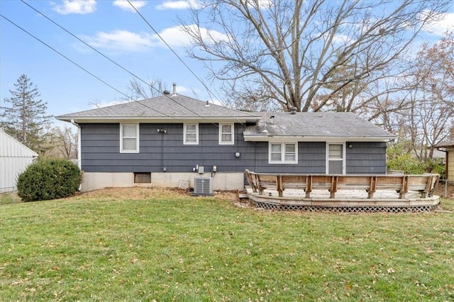 rear view of property with a yard, central AC, and a deck