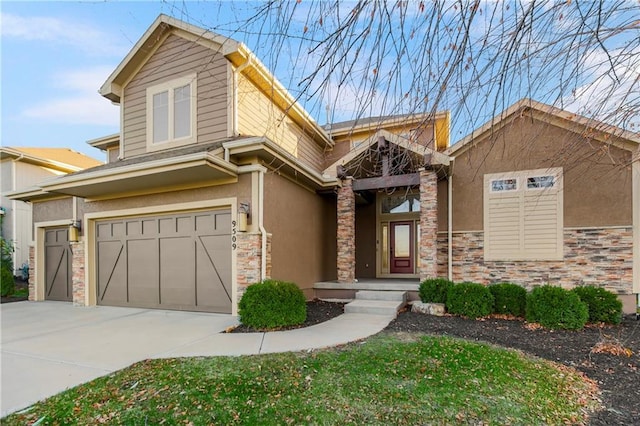 9509 W 164th St, Stilwell, KS 66085 - view of front facade with stucco siding, an attached garage, concrete driveway, and stone siding
