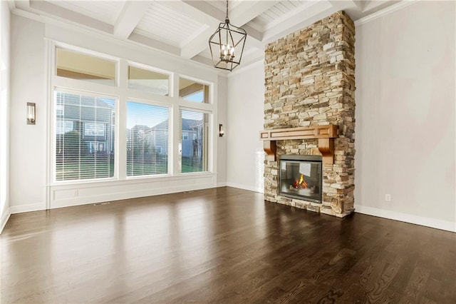 9509 W 164th St, Stilwell, KS 66085 - unfurnished living room featuring plenty of natural light, beamed ceiling, wood finished floors, a chandelier, and a stone fireplace
