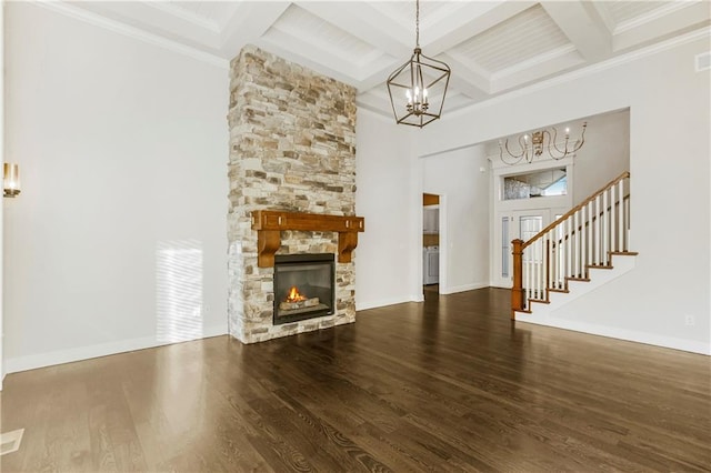 9509 W 164th St, Stilwell, KS 66085 - unfurnished living room featuring a chandelier, beamed ceiling, coffered ceiling, wood finished floors, and a fireplace