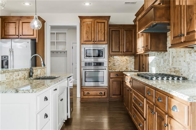 9509 W 164th St, Stilwell, KS 66085 - kitchen with stainless steel appliances, premium range hood, dark wood finished floors, light stone counters, and backsplash
