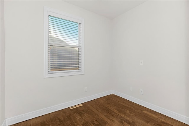 9509 W 164th St, Stilwell, KS 66085 - empty room featuring baseboards and dark wood-type flooring