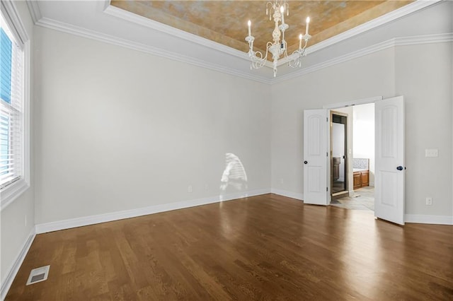 9509 W 164th St, Stilwell, KS 66085 - empty room featuring a raised ceiling, a chandelier, wood finished floors, and ornamental molding