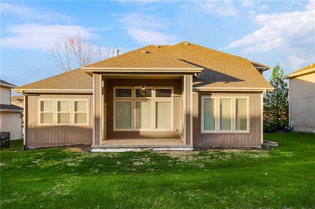 rear view of house with a yard