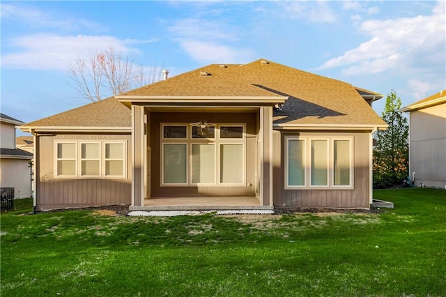 9509 W 164th St, Stilwell, KS 66085 - back of property with a shingled roof and a yard