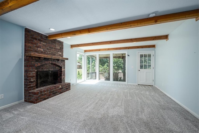 unfurnished living room with beam ceiling, a fireplace, carpet, and baseboards