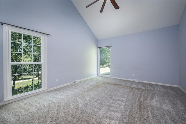 carpeted empty room featuring visible vents, high vaulted ceiling, baseboards, and a ceiling fan