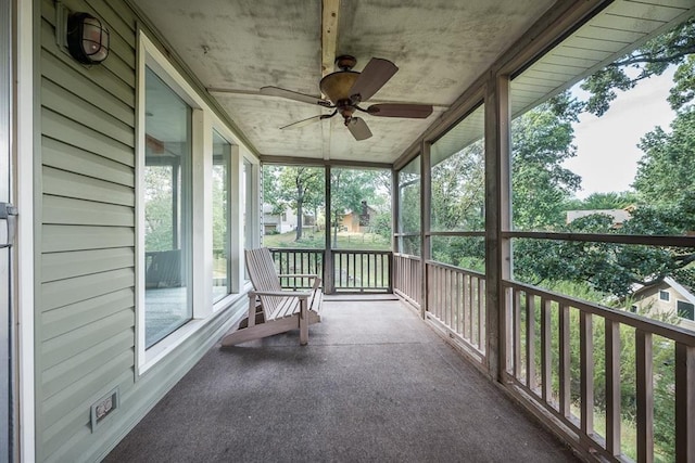 unfurnished sunroom with a ceiling fan