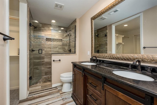 bathroom with a sink, visible vents, and a stall shower