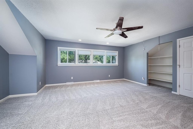 unfurnished bedroom featuring visible vents, carpet, baseboards, and a textured ceiling