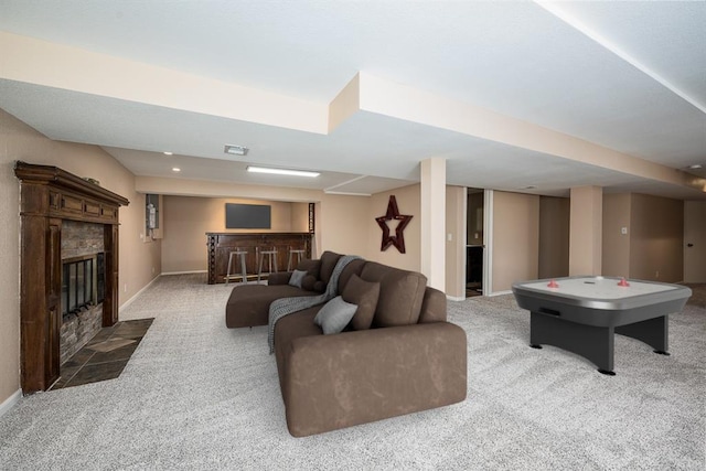 carpeted living room featuring recessed lighting, visible vents, baseboards, and a tile fireplace