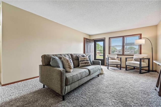 carpeted living room featuring a textured ceiling