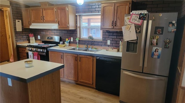 423 Elm St, Mound City, KS 66056 - kitchen with backsplash, ventilation hood, stainless steel appliances, sink, and light hardwood / wood-style floors