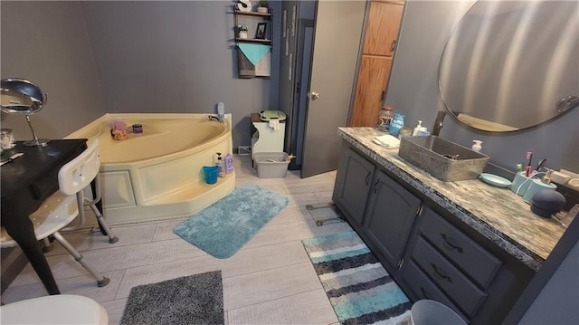 423 Elm St, Mound City, KS 66056 - bathroom featuring tile patterned flooring, vanity, and a washtub
