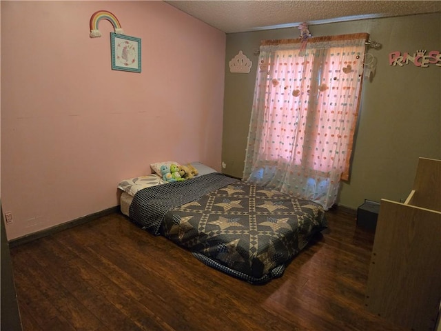 423 Elm St, Mound City, KS 66056 - bedroom with wood finished floors and a textured ceiling