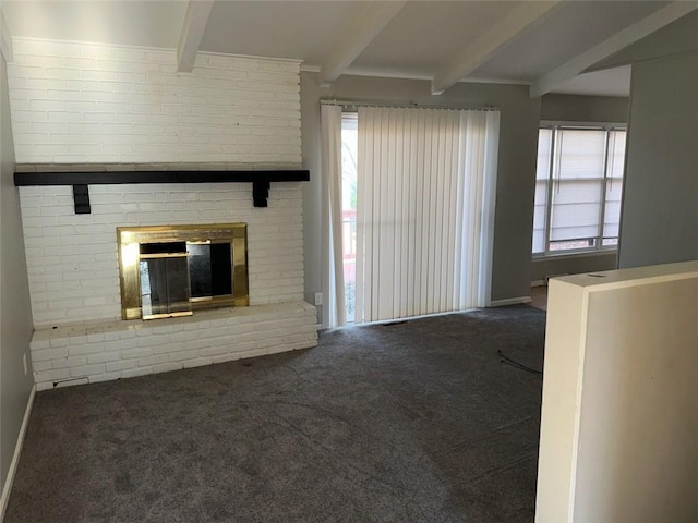 unfurnished living room with dark carpet, beamed ceiling, and a fireplace