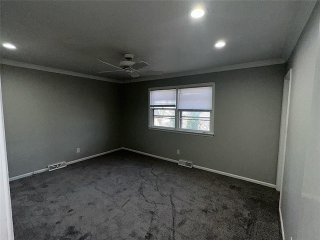 empty room with ceiling fan, crown molding, and dark carpet