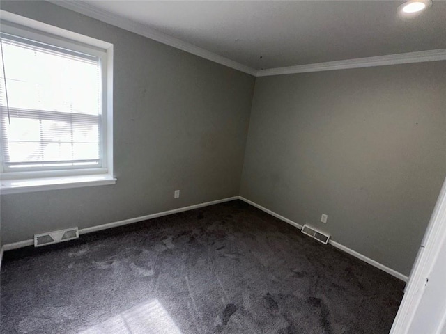 unfurnished room featuring crown molding and dark colored carpet