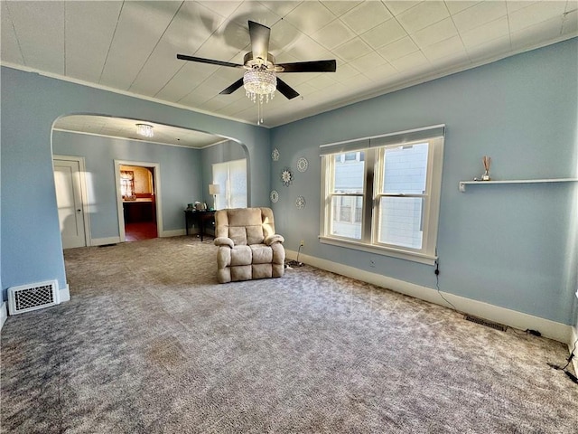 unfurnished room featuring carpet flooring, ceiling fan, and crown molding