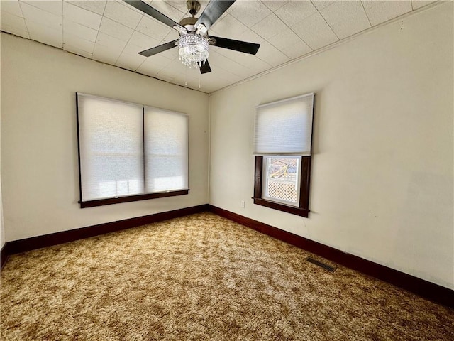 carpeted spare room featuring ceiling fan