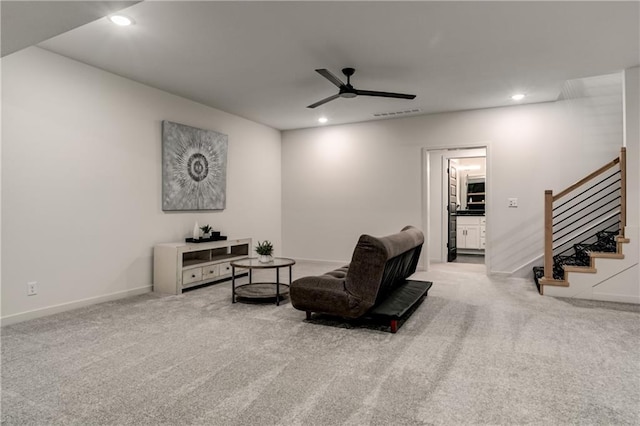 sitting room with ceiling fan and light carpet